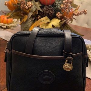 Dooney & Bourke Purse (small). Navy with brown trim. Very good condition.